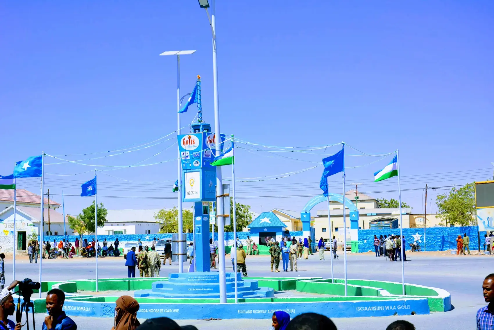 A square with flags and a fountain in Garowe