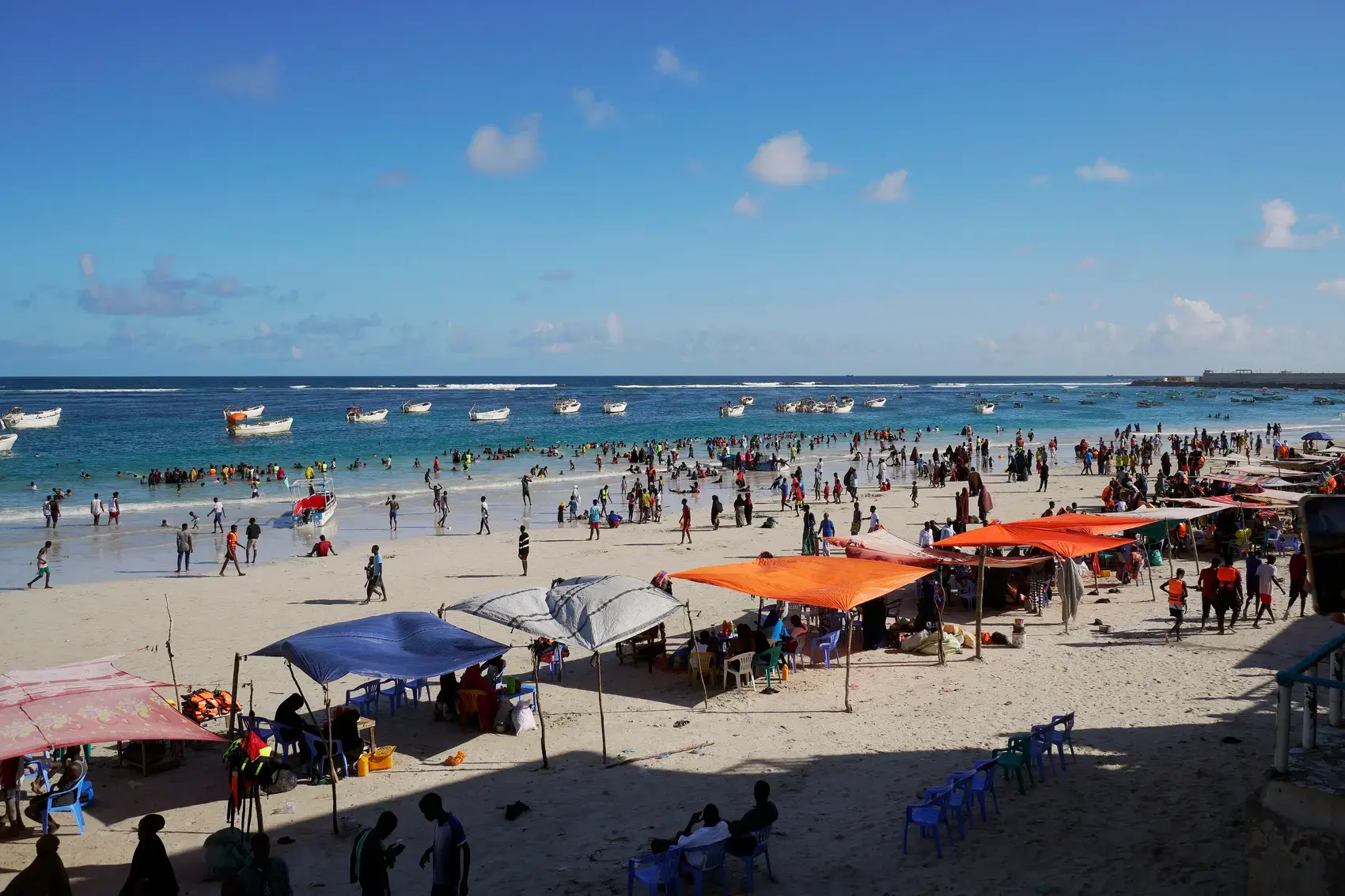 Crowds and shade stalls on Lido Beach in Mogadishu