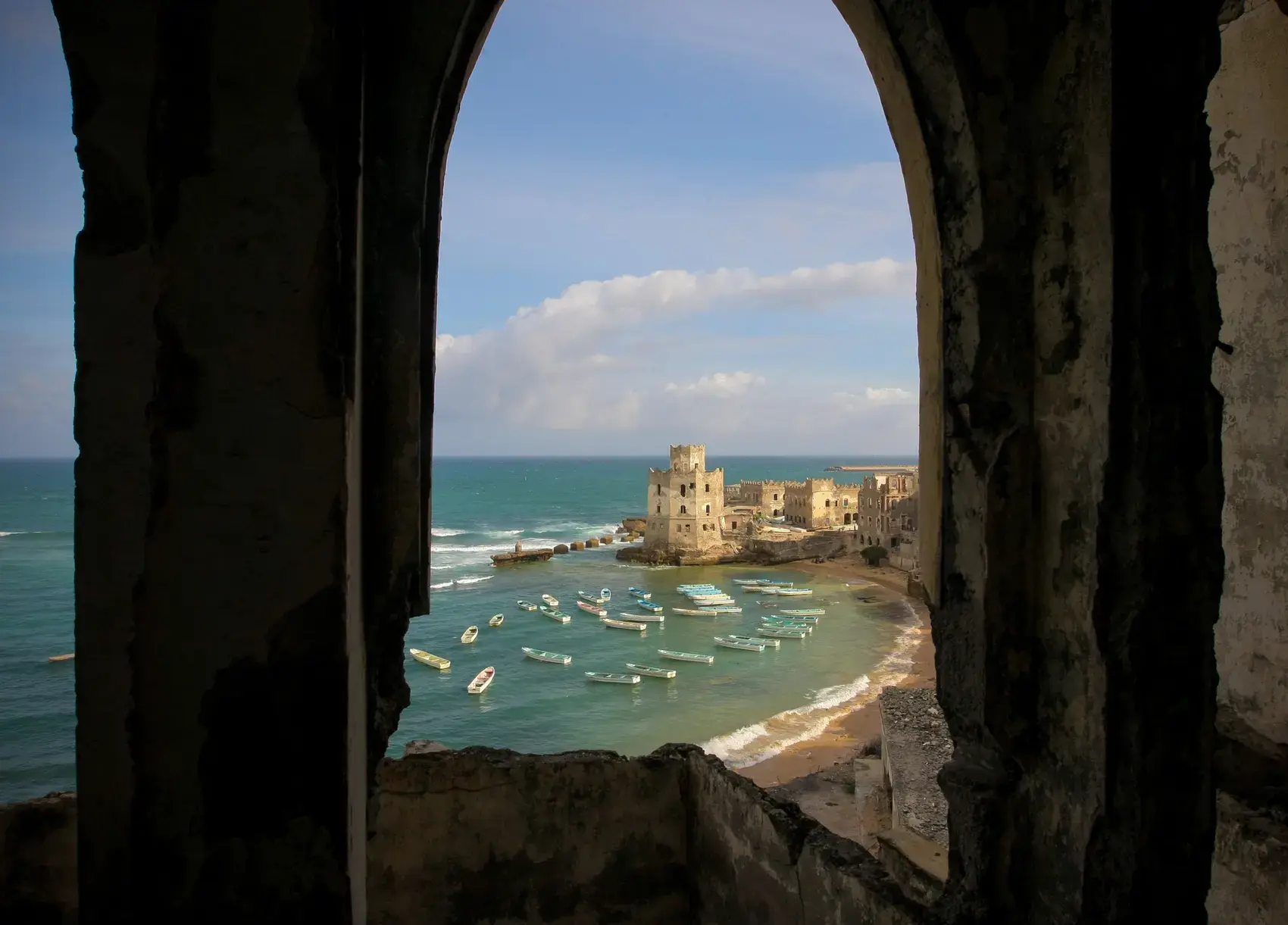 Mogadishu's old port seen through a ruined archway